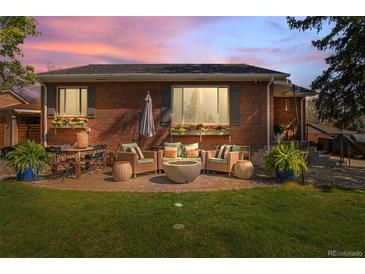 Cozy brick patio with comfortable outdoor seating and a modern fire pit, perfect for relaxing evenings at 6925 W 27Th Ave, Wheat Ridge, CO 80033