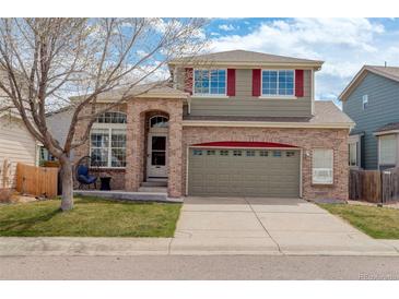 Charming two-story home with brick facade, two-car garage, and landscaped front yard at 5368 Creek Way, Parker, CO 80134