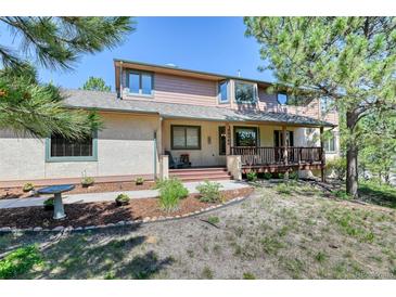 Charming two-story home with a covered front porch and well-maintained landscaping at 20380 Silver Horn Ln, Monument, CO 80132