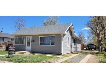 Charming single-story home featuring gray siding, a well-maintained lawn, and a classic architectural design at 276 N 9Th N Ave, Brighton, CO 80601