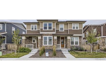 Attractive home exterior with stone accents, neutral siding, and a well-maintained lawn at 6233 N Liverpool St, Aurora, CO 80019