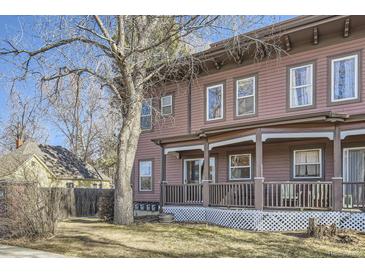 Charming multi-story home with a covered front porch and mature trees at 820 Kimbark St # B, Longmont, CO 80501