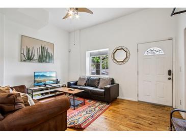 Cozy living room with hardwood floors, comfortable seating, and a decorative rug at 915 26Th St, Denver, CO 80205
