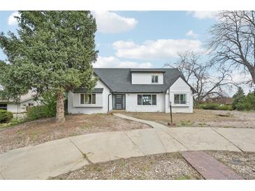 Charming single-Gathering home with a white brick exterior and a gray roof at 796 S Bristol St, Lakewood, CO 80228