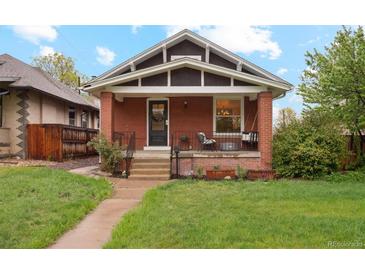 Charming red brick bungalow with a cozy front porch and well-maintained lawn at 2765 W Denver Pl, Denver, CO 80211