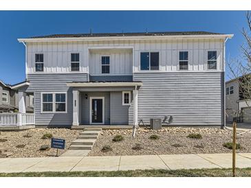Charming two-story home with gray siding, complemented by a well-maintained lawn and inviting entrance at 1978 S Haleyville Way, Aurora, CO 80018