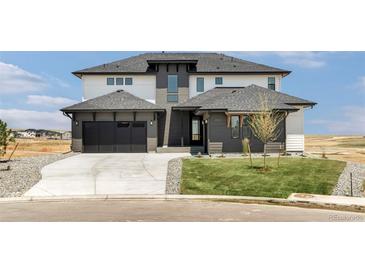 Beautiful two-story home with a modern design, spacious garage, and well-manicured lawn at 39441 Stockton Cir, Elizabeth, CO 80107