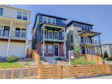 Charming two-story home boasting a blue exterior, brick accents, dual balconies and landscaped front yard at 11063 Shining Star Cir, Parker, CO 80134