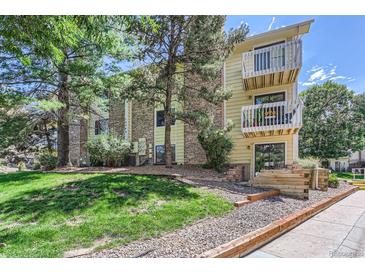 Two-story apartment building with brick accents, multiple balconies, and well maintained lawn with mature landscaping at 12504 E Cornell Ave # 103, Aurora, CO 80014