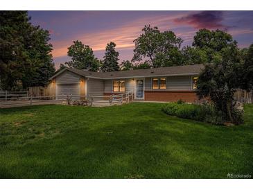 Charming ranch home with a lush green lawn, mature trees, and a freshly painted exterior at 3272 S Joplin Ct, Aurora, CO 80013