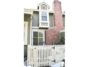 Charming home exterior with a picket fence, brick chimney and well-maintained siding at 2090 S Hannibal Way # C, Aurora, CO 80013