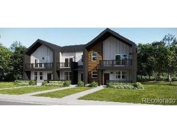 Modern townhome featuring a private balcony, two-car garage and landscaped yard at 8909 San Antonio St, Littleton, CO 80125