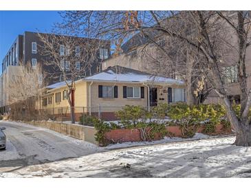 Brick ranch home with a fenced yard and mature landscaping at 2042 S Josephine St # 2, Denver, CO 80210