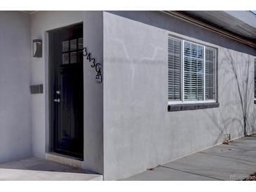 Modern front door with a sleek black finish at 3430 N Cook St, Denver, CO 80205