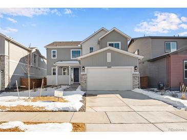 Charming two-story home with a two-car garage, covered porch, and well-maintained front yard at 10022 Wheeling St, Commerce City, CO 80022