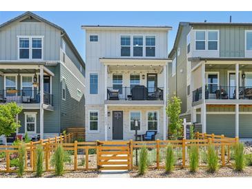 Charming two-story home with a fenced front yard and balcony, perfect for enjoying the outdoors at 14952 Gladshine Dr, Parker, CO 80134