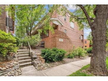 Charming brick building with lush landscaping and inviting entrance steps to the covered entryway, 3030 at 3030 Wyandot St # 4, Denver, CO 80211
