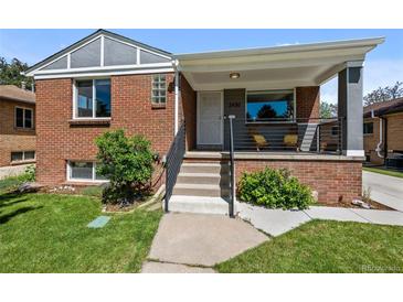 Charming brick home with a cozy front porch and well-maintained landscaping at 2430 S Ogden St, Denver, CO 80210