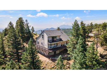 Stunning mountain home with wrap-around deck and picturesque views from a wooded lot at 251 Ridgeview Ln, Boulder, CO 80302