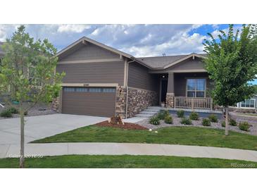 Charming single-Gathering home with a well-manicured lawn, stone accents, and an attached two-car garage at 22345 E Bailey Pl, Aurora, CO 80016