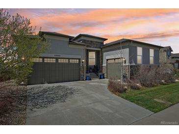 Stunning home exterior featuring a three car garage and meticulous landscaping at 27423 E Euclid Dr, Aurora, CO 80016