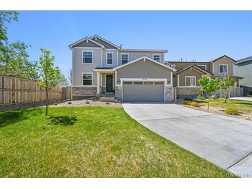 Charming two-story home with a well-manicured lawn and a two-car garage at 5078 S Quail St, Littleton, CO 80127