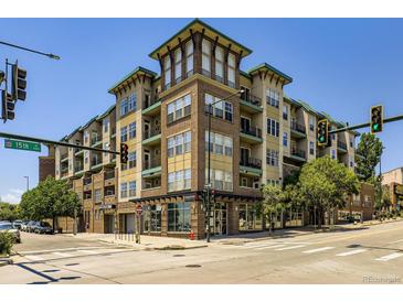 Modern multi-story building with brick and siding, showcasing a contemporary urban living space with many windows and street access at 1441 Central # 305, Denver, CO 80211