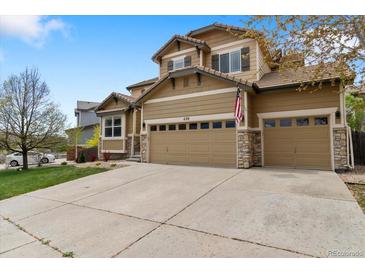 Charming two-story home featuring a three-car garage and well-maintained front yard at 420 Graham Cir, Erie, CO 80516