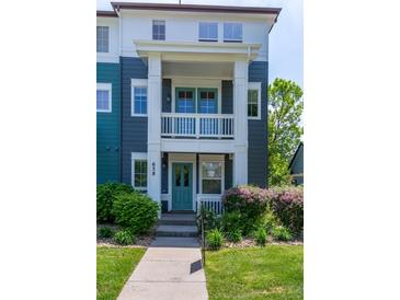 Charming two-story townhome with a covered porch, well-manicured lawn, and lush landscaping at 658 Casper Dr, Lafayette, CO 80026