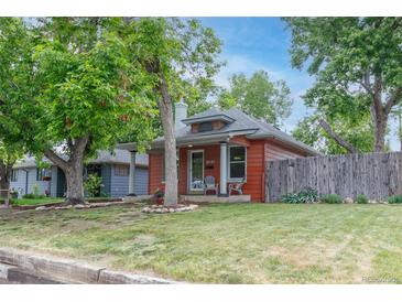 Charming single-story home featuring well-maintained landscaping and a cozy front porch at 4841 Alcott St, Denver, CO 80221