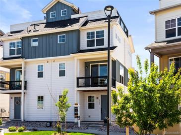 Charming three-story home with a balcony, modern design, and well-maintained landscaping at 6162 W 28Th Ct, Edgewater, CO 80214