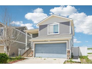 Charming two-story home with a two-car garage and staircase leading to the front door at 5571 Killarney St, Denver, CO 80249