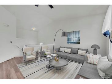 Bright living room with plush seating, modern decor, and stylish furnishings on hardwood floors at 5571 Killarney St, Denver, CO 80249