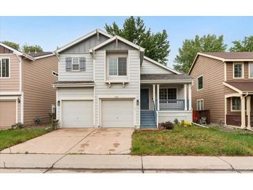Charming two-story home featuring a well-maintained front yard and a convenient two-car garage at 1241 S Akron Way, Denver, CO 80247
