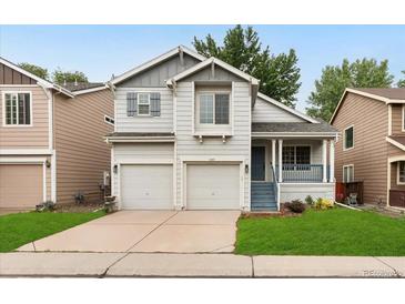 Charming two-story home with a two-car garage, covered porch, and well-maintained lawn at 1241 S Akron Way, Denver, CO 80247