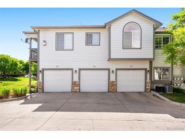 Inviting townhome featuring a private garage and well-maintained landscaping at 3242 E 103Rd Dr # 602, Thornton, CO 80229