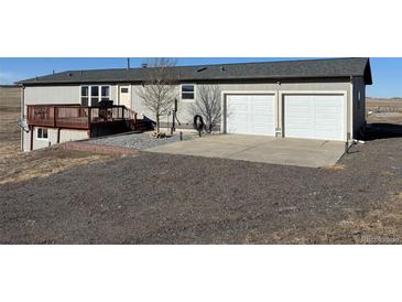 Charming home with two-car garage and wooden deck, beautifully set on a spacious lot at 11100 Haskell Creek Rd, Larkspur, CO 80118