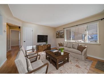 Bright living room with hardwood floors, comfy seating, and large windows at 4157 Perry St, Denver, CO 80212