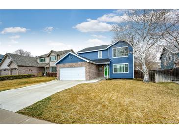 Charming two-story home with blue siding, brick accents, and a well-manicured lawn at 12842 Bellaire St, Thornton, CO 80241