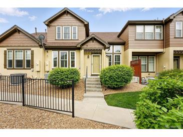 Charming townhouse featuring a landscaped front yard, steps to the front door, and decorative touches at 5836 S Vivian Way, Littleton, CO 80127