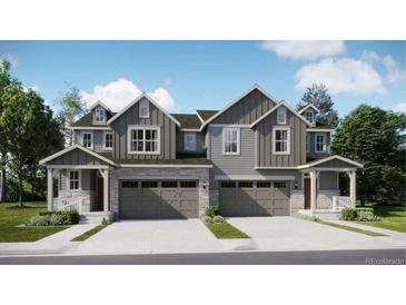 Charming duplex featuring stone accents, two-car garages, and inviting covered porches at 6719 Juniper Dr, Thornton, CO 80602