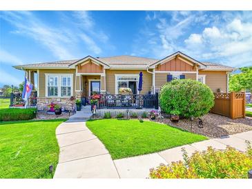 Charming single-story home with inviting front porch, well-manicured lawn, and colorful flower arrangements at 3751 W 136Th Ave # F4, Broomfield, CO 80023