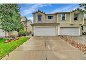 Two-story townhome with attached two-car garage and concrete driveway at 7946 S Kittredge St, Englewood, CO 80112