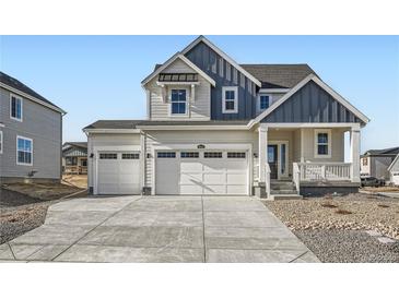 Two-story house with gray and white siding, two-car garage, and landscaping at 39610 Congress Ln, Elizabeth, CO 80107