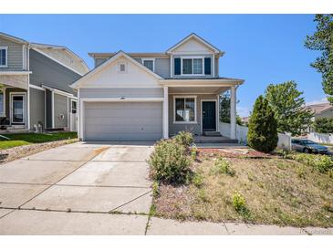 Charming two-story home with a well-manicured lawn and inviting front porch and attached two car garage at 20108 Randolph Pl, Denver, CO 80249