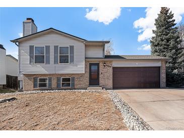 Traditional home with attached garage and lovely front yard at 4025 S Fundy Way, Aurora, CO 80013