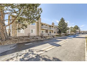 Exterior view of the condo building with stone accents and private balconies at 4400 S Quebec St # 204T, Denver, CO 80237