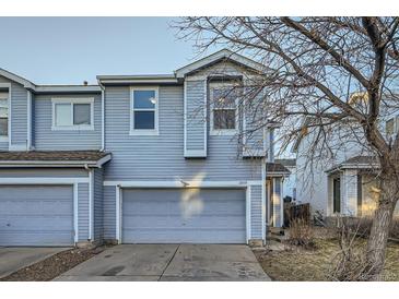 Two-story home featuring an attached two-car garage and light blue siding at 11039 Columbine St, Northglenn, CO 80233