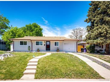 Charming one-story home featuring a well-manicured lawn and inviting walkway to the front door at 1183 S Umatilla St, Denver, CO 80223