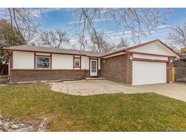 Brick ranch home with a paved patio and attached garage at 11368 Lamar St, Westminster, CO 80020